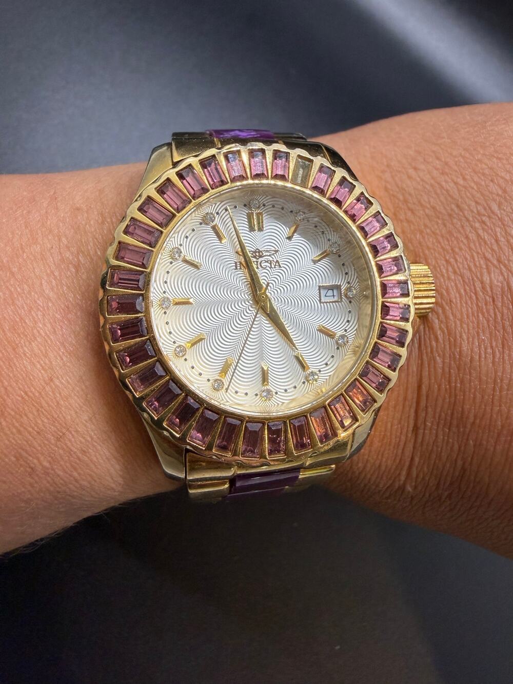 Invicta Angel model 18880 gold-toned case, silver dial, and purple crystal beze